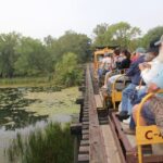 People travel by open air rail through the Tiffany Bottoms
