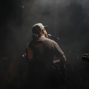 the back of a musician playing guitar on stage