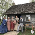 Five people dressed in era clothes from the time of Laura Ingalls Wilder's childhood