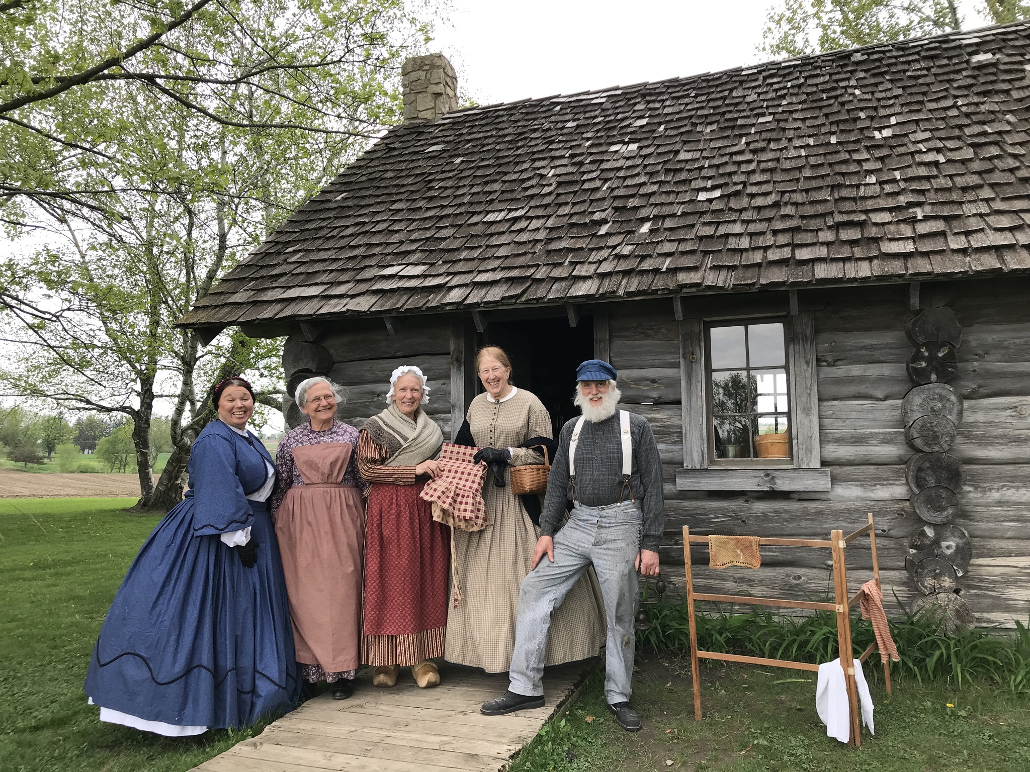 Five people dressed in era clothes from the time of Laura Ingalls Wilder's childhood