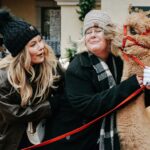 two women with a lama in winter