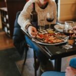 a couple enjoys pizza and wine