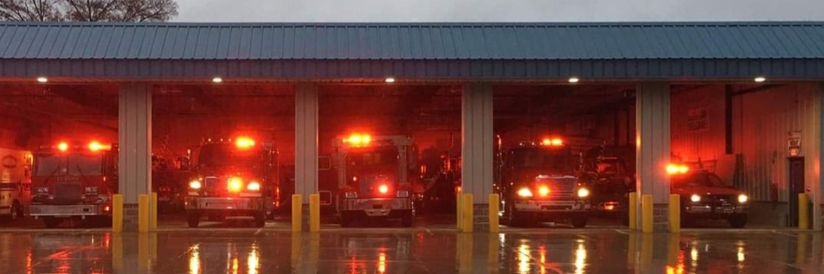 A tow of fire trucks lit up in their garage