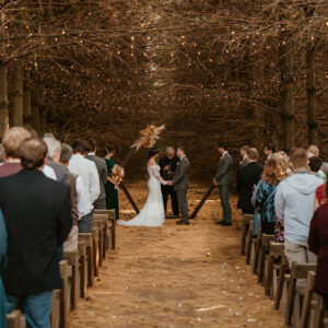 A couple gets married in an evergreen forest