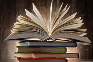 A stack of books with the top one open