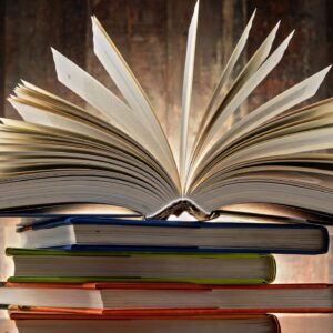 A stack of books with the top one open