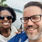 A smiling man and woman in front of lake pepin