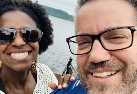 A smiling man and woman in front of lake pepin