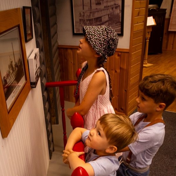 three children enjoying the laura ingalls wilder museum.