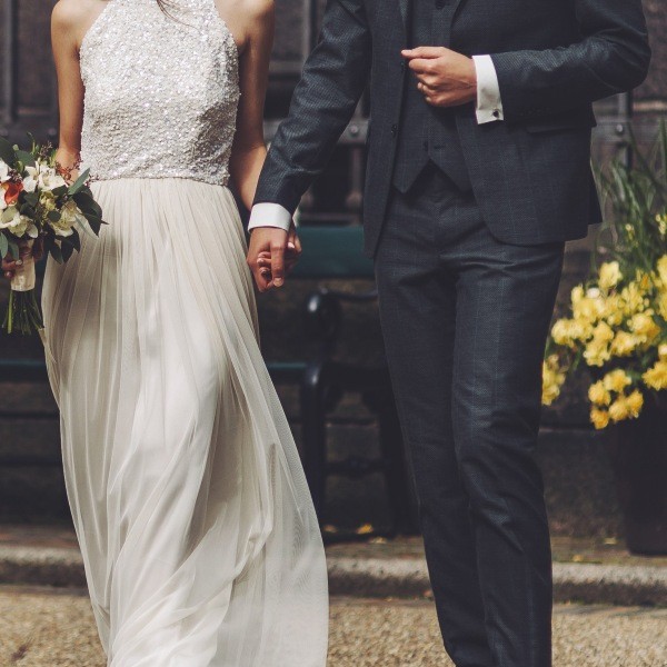 a bride and groom hold hands