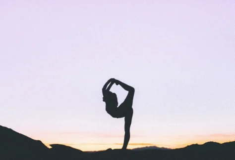 silhouette figure doing a yoga pose