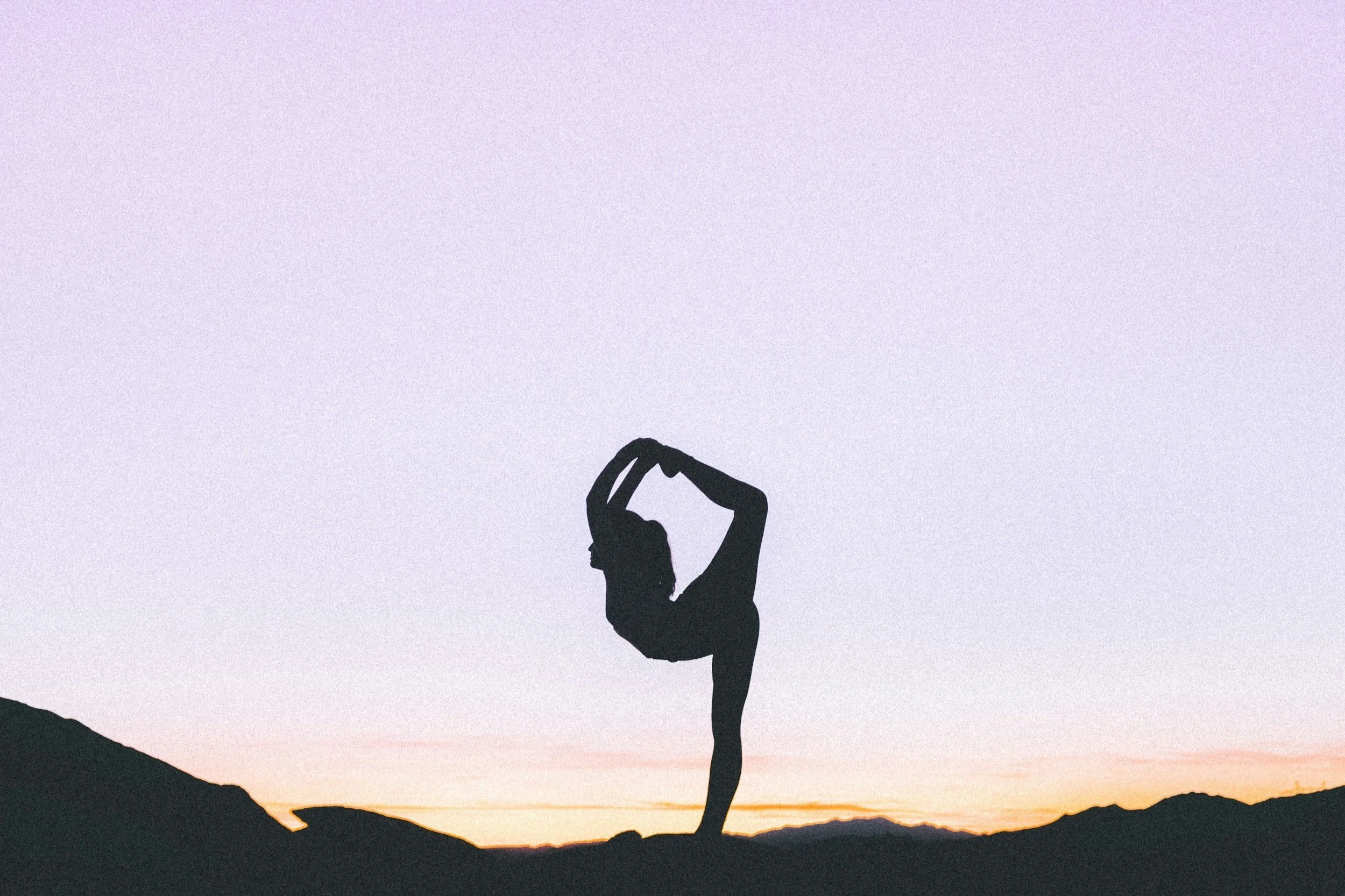 silhouette figure doing a yoga pose