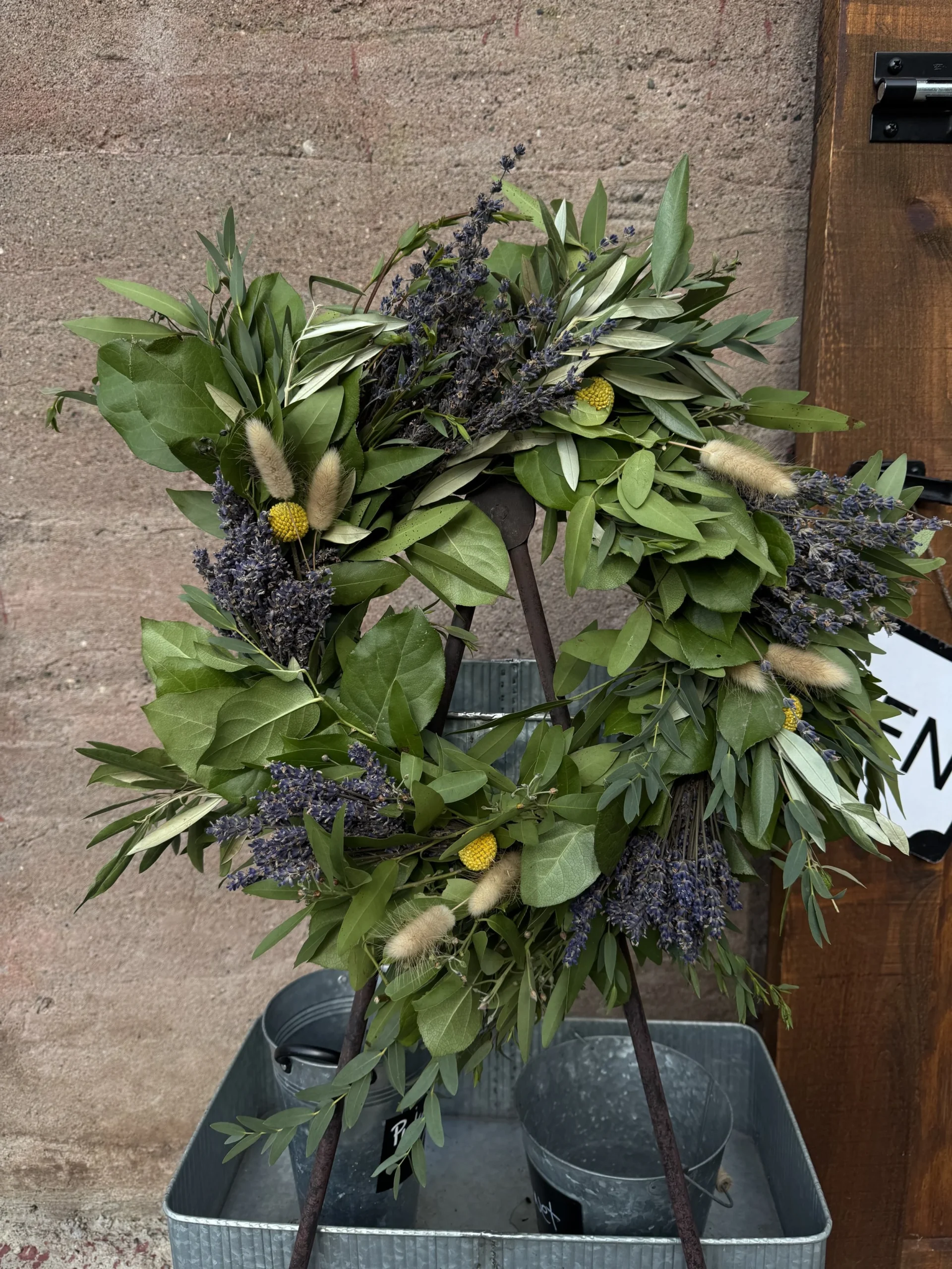 dried lavender wreath hanging on an easel