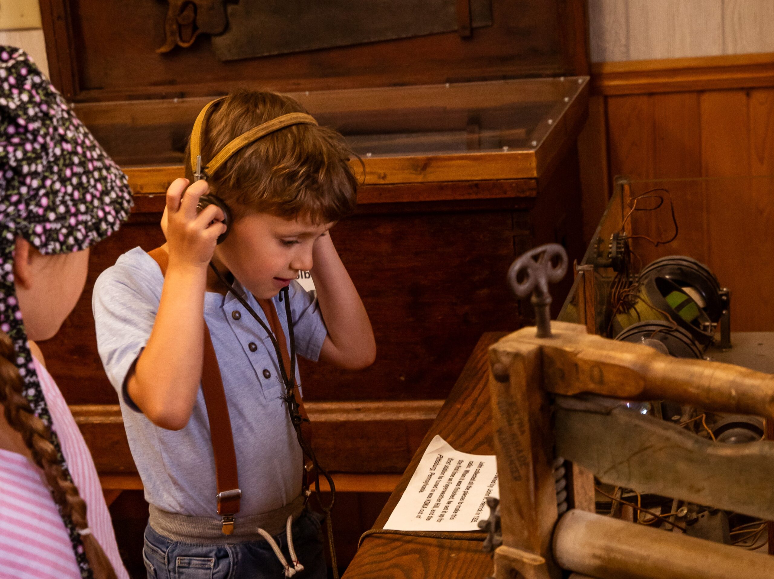 A boy interacts with a museum display